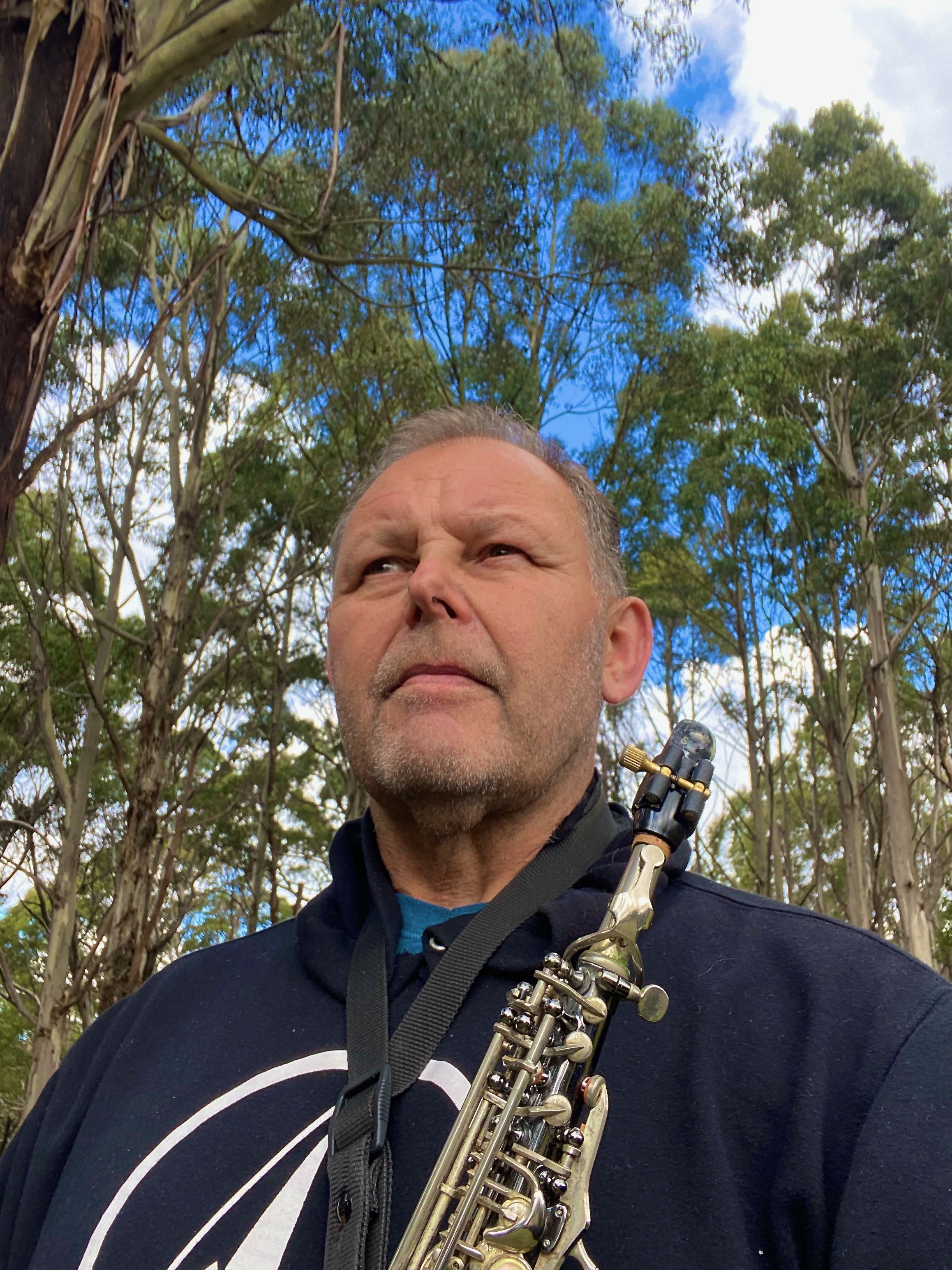 Robert Vincs with saxophone outdoors